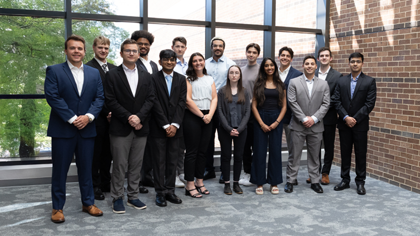 Early IT career staff standing inside office building